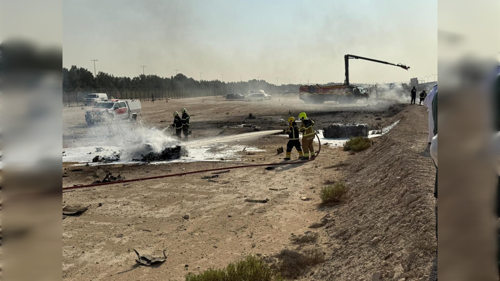 Firefighters extinguish burning debris at the Tejas jet crash site during the Dubai Airshow.