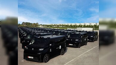 A fleet of WeRide driverless Robotaxi vehicles lined up in Abu Dhabi.