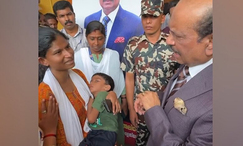 Yusuff Ali speaks with a mother holding her bedridden son during a visit to Kollam, Kerala, offering assistance for the child’s treatment.