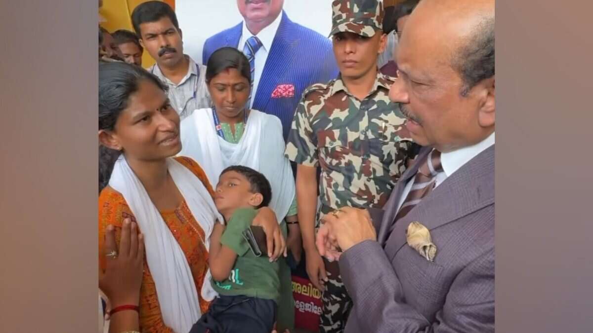 Yusuff Ali speaks with a mother holding her bedridden son during a visit to Kollam, Kerala, offering assistance for the child’s treatment.