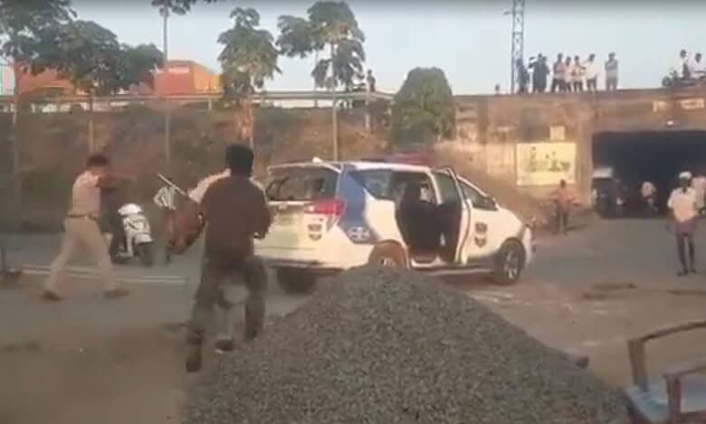 Image shows few people around a police vehicle in Adilabad