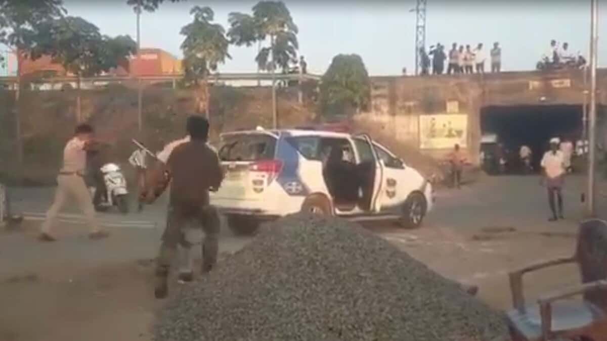 Image shows few people around a police vehicle in Adilabad