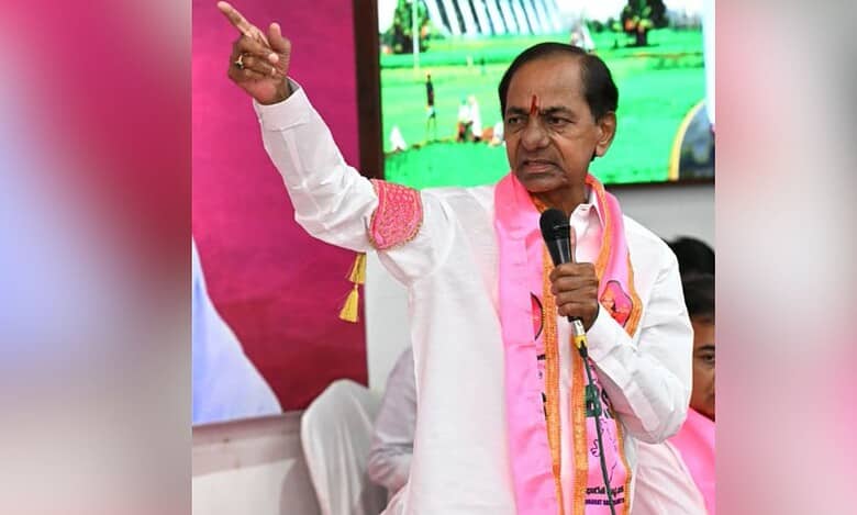 K. Chandrashekar Rao (KCR), BRS party leader, speaking at a public event in Telangana with pink party branding visible in the background