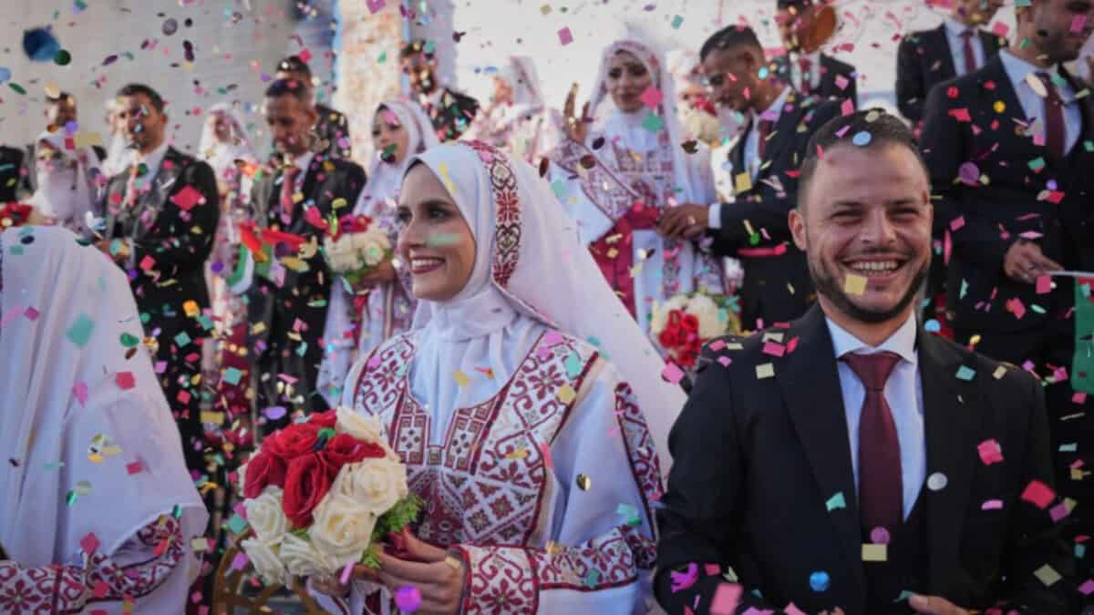 Palestinian couples participate in a mass wedding ceremony in Hamad City in Khan Younis, Gaza Strip