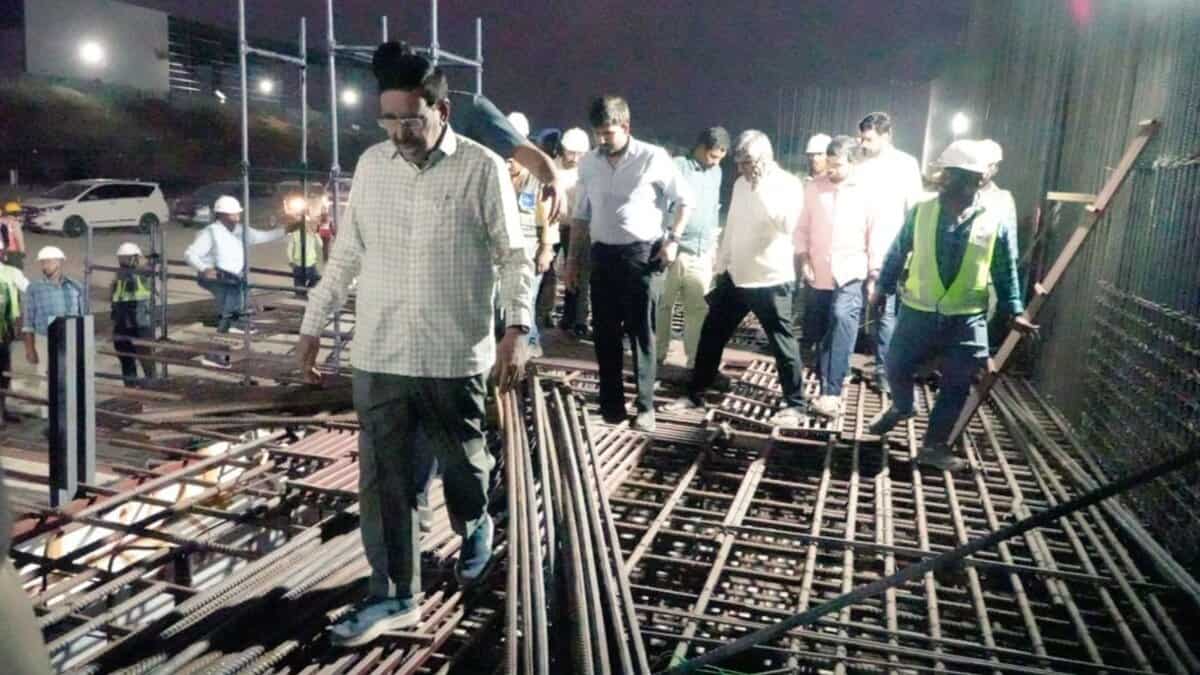 Construction site inspection with engineers and workers at night focusing on steel reinforcement.
