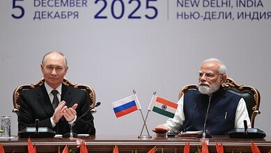 Russian President Vladimir Putin and Indian Prime Minister Narendra Modi seated at a formal diplomatic meeting with Russian and Indian flags, dated December 5, 2025, in New Delhi, India.