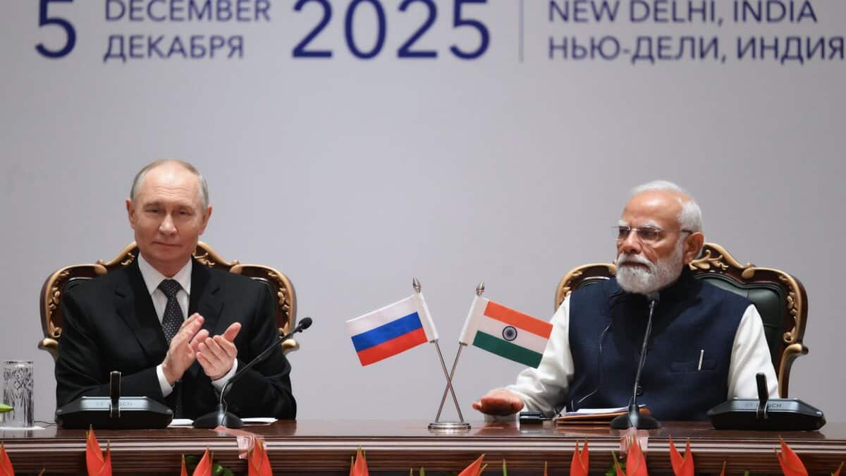 Russian President Vladimir Putin and Indian Prime Minister Narendra Modi seated at a formal diplomatic meeting with Russian and Indian flags, dated December 5, 2025, in New Delhi, India.