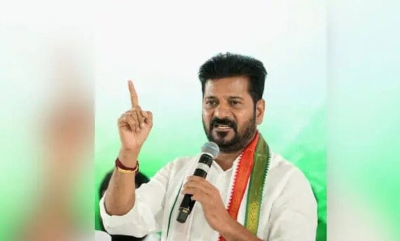 Image shows Telangana Chief Minister Revanth Reddy holding a mic