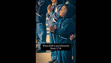 School boy dances during prayer