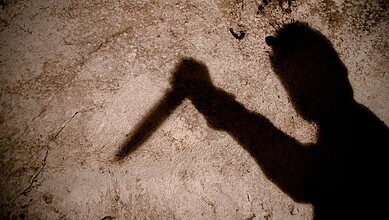Shadow of man holding a knife