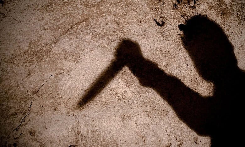 Shadow of man holding a knife