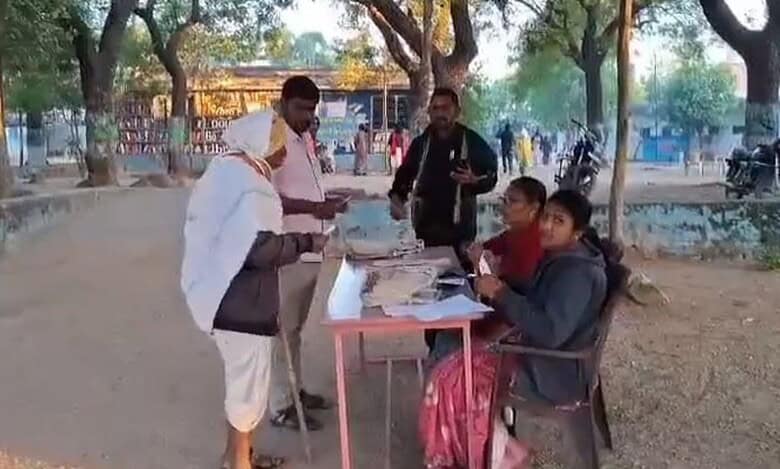 A voter arrives at a polling station in Karimnganar