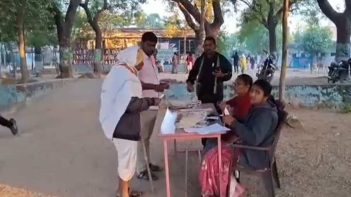 A voter arrives at a polling station in Karimnganar