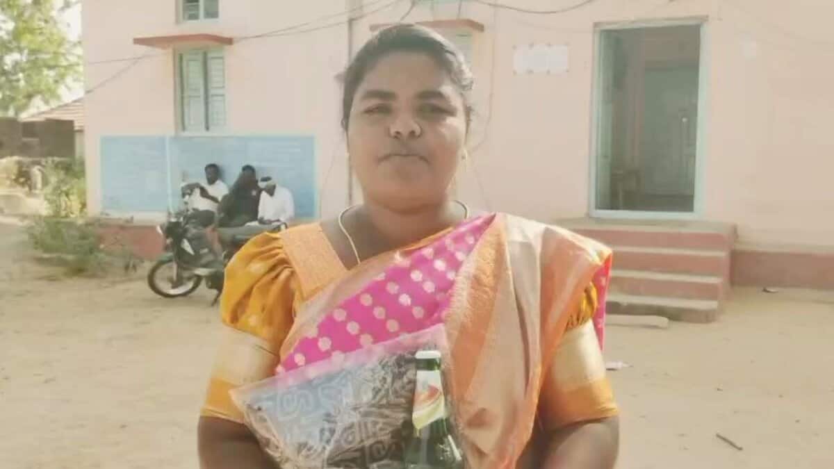 A woman returns beer and saree given by a losing candidate in Telangana