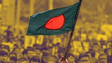 A Bangladeshi flag being raised in a protest.