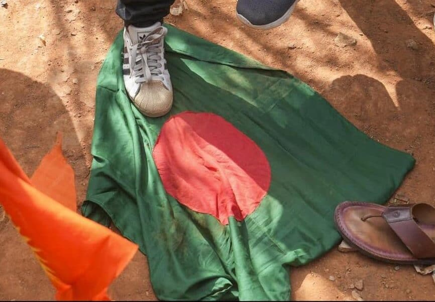 The national flag of Bangladesh lies on ground during a protest by members of various Hindu organisations condemning reported incidents of violence against Hindus in the neighbouring country, in Bengaluru.