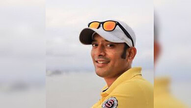 image shows YouTuber Anvesh wearing a white cap and sunglasses