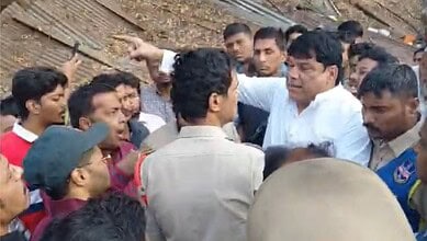 People argue with police during an encroachment drive in Afzalgunj