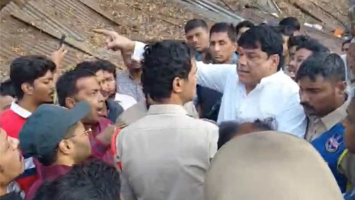 People argue with police during an encroachment drive in Afzalgunj