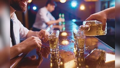 Image showing a man pouring alcoholic drink in glass at a bar