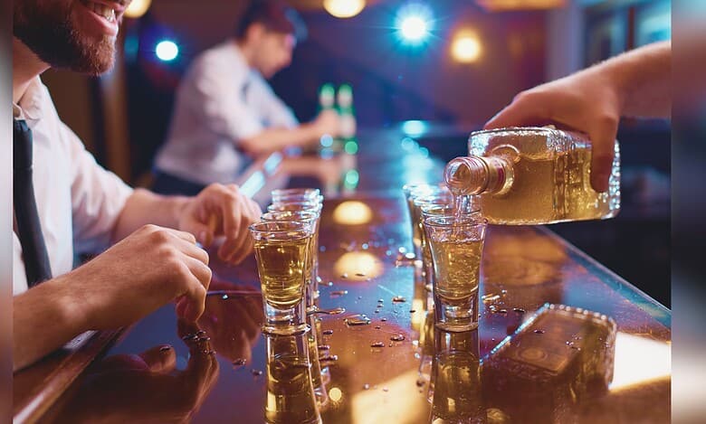 Image showing a man pouring alcoholic drink in glass at a bar