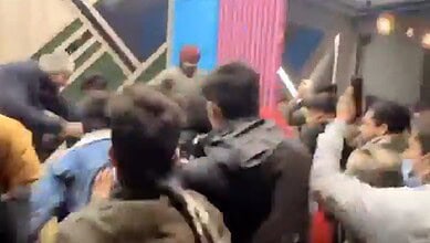 Screengrab of video where a crowd is seen beating up two men