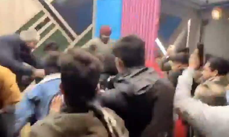 Screengrab of video where a crowd is seen beating up two men