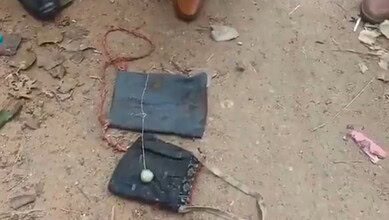 Image shows two cloth bags on the ground and a circular object on one of it