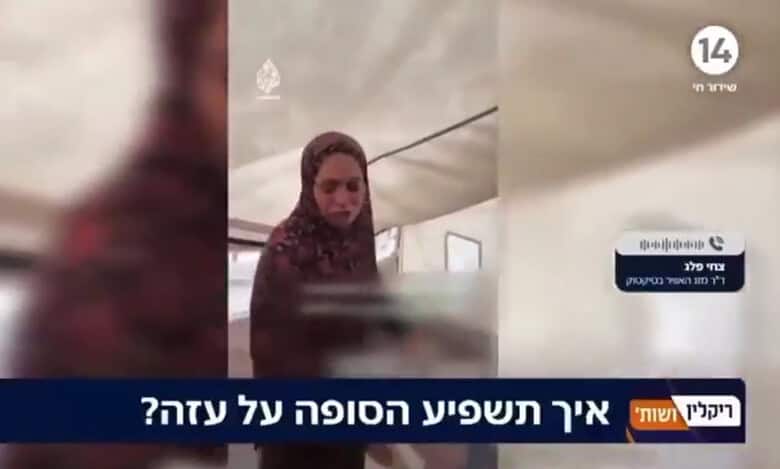 A woman struggles to keep herself warm inside a tent in Gaza