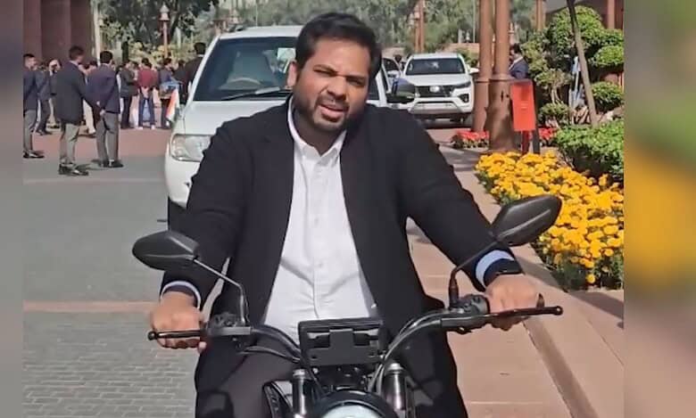 Congress MP representing Telangana's Peddapalli constituency, Gaddam Vamsi Krishna drives an electric bike on his way to the Parliament to raise awareness about Delhi's rising air pollution.