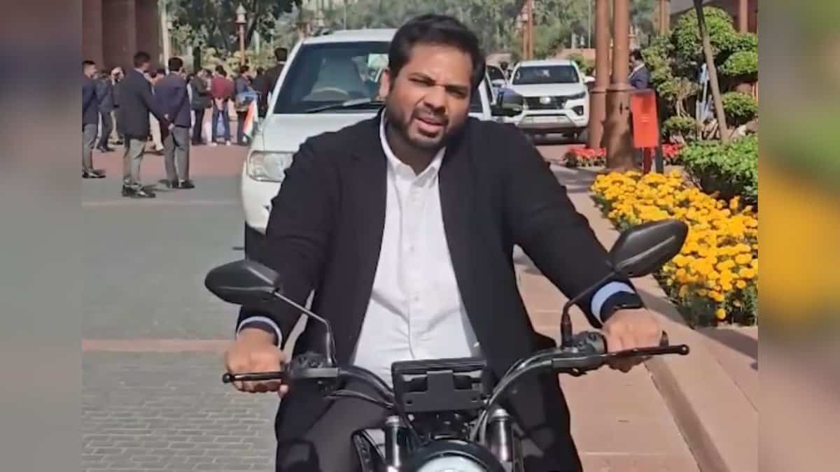 Congress MP representing Telangana's Peddapalli constituency, Gaddam Vamsi Krishna drives an electric bike on his way to the Parliament to raise awareness about Delhi's rising air pollution.