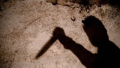 shadow of a man with a big knife