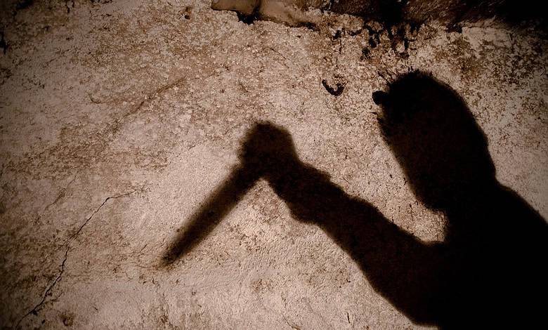shadow of a man with a big knife