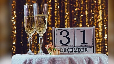 Image shows two champagne glasses alongside a calendar reading December 31