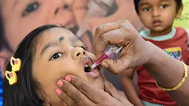 A child being administered a Polio vaccine.