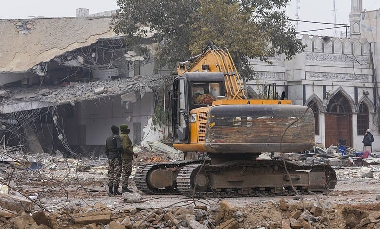 New Delhi: Men stand at the entrance of Syed Faiz Elahi mosque amid debris after demolition of alleged encroachments on land adjoining the mosque by the Municipal Corporation of Delhi