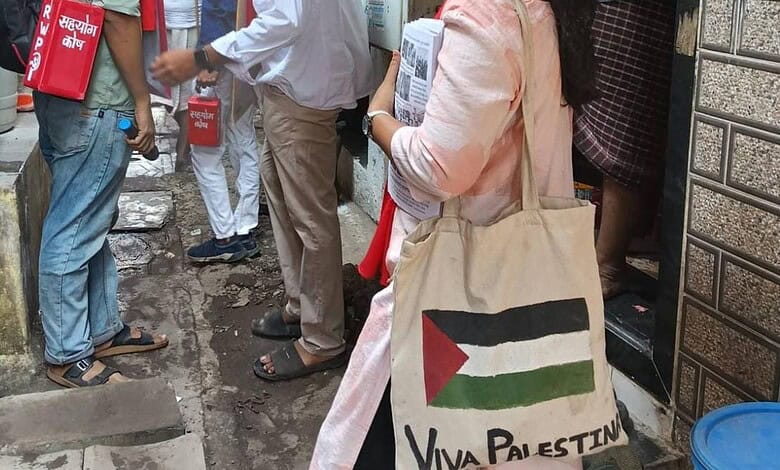 A supporter of RWI candidate carries a bad with a Palestinian flag artwork