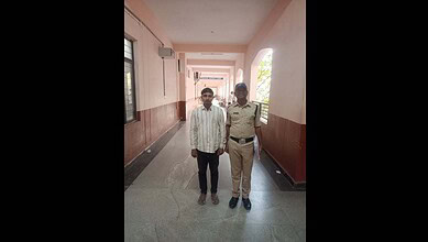 Convict Mohammed Siraj is seen with a police official