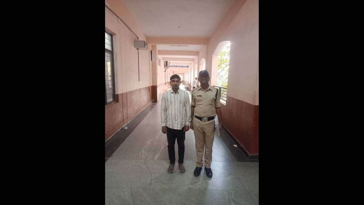 Convict Mohammed Siraj is seen with a police official