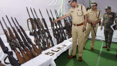 Telangana DGP B Shivadhar Reddy, along with officials, inspects seized arms and ammunition from Maoists, in Hyderabad.
