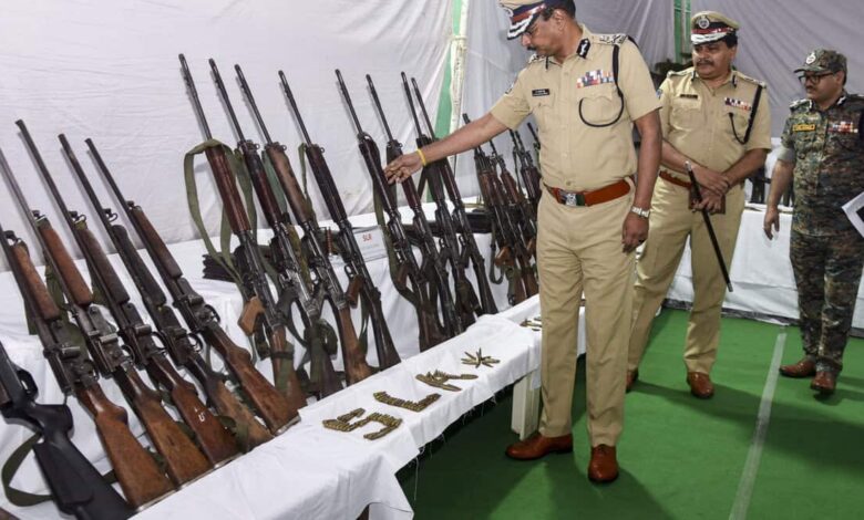 Telangana DGP B Shivadhar Reddy, along with officials, inspects seized arms and ammunition from Maoists, in Hyderabad.