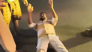 A man lies on the road in Hyderabad