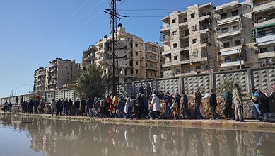 Civilians evacuate an area of the Sheikh Maqsoud neighborhood, where clashes between government forces and Kurdish fighters have been taking place in the northern city of Aleppo, Syria on Saturday. (AP Photo/Omar Albam)