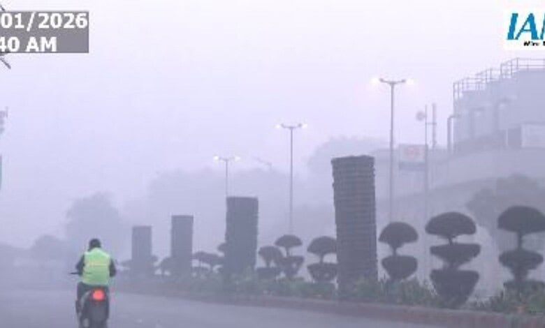 A man on his way to work amid poor AQI in Delhi