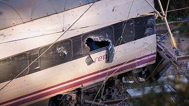 Part of a wrecked train is photographed at the site of a train collision in Adamuz, southern Spain, Monday, Jan. 19, 2026