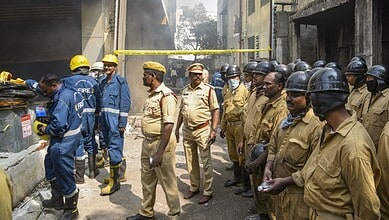Police personnal and firefighters during a cooling and rescue operation after a fire broke out in a four-storey furniture shop building on Saturday, at Nampally, in Hyderabad -