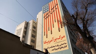 An anti-.US mural on a building in Tehran, Iran says ‘Down with the USA’ (via REUTERS)