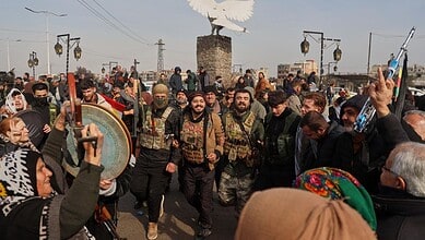 Kurdish fighters with the Syrian Democratic Forces (SDF) are cheered by local residents ahead of the end of a four-day truce with the Syrian government in Hassakeh, northeastern Syria, Saturday, Jan. 24, 2026.