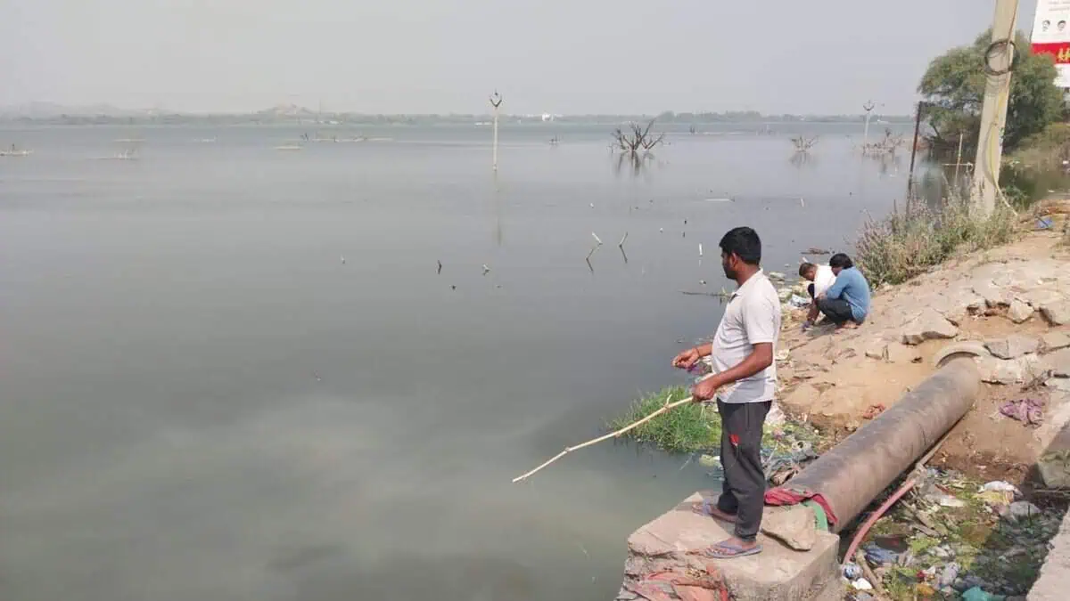 Anglers wait patiently to catch a fish or two at the Bibinagar Lake