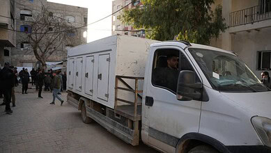 An ICRC Vehicle with Palestinian bodies enters Gaza,